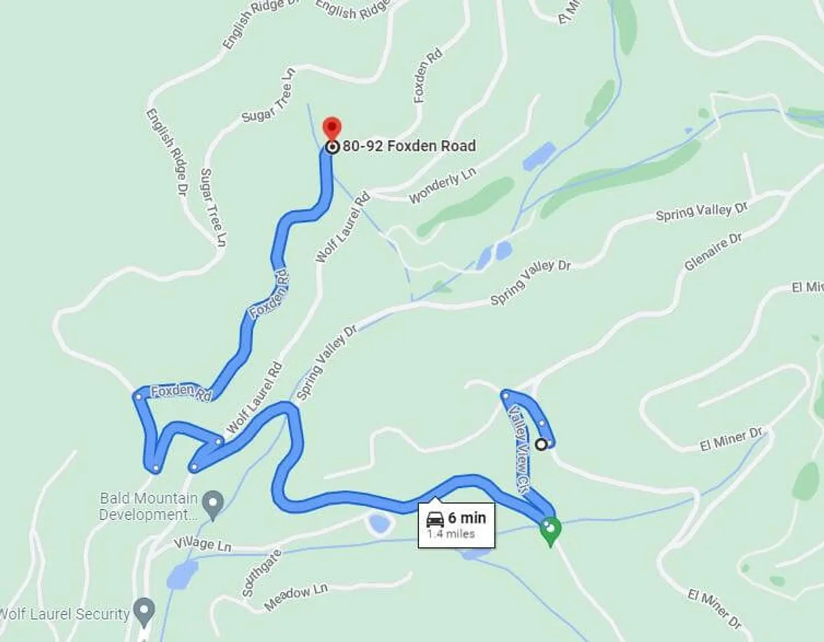 A winding mountain road, bordered by lush greenery and softly lit by the golden rays of sunset. The peaceful setting conveys a sense of escape and anticipation, inviting couples to journey toward their secluded romantic retreat.